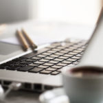 Closeup of Workspace with Modern Creative Laptop, Cup of Coffee